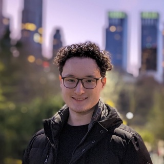 Ben Ashdown, smiling in front of a city skyline